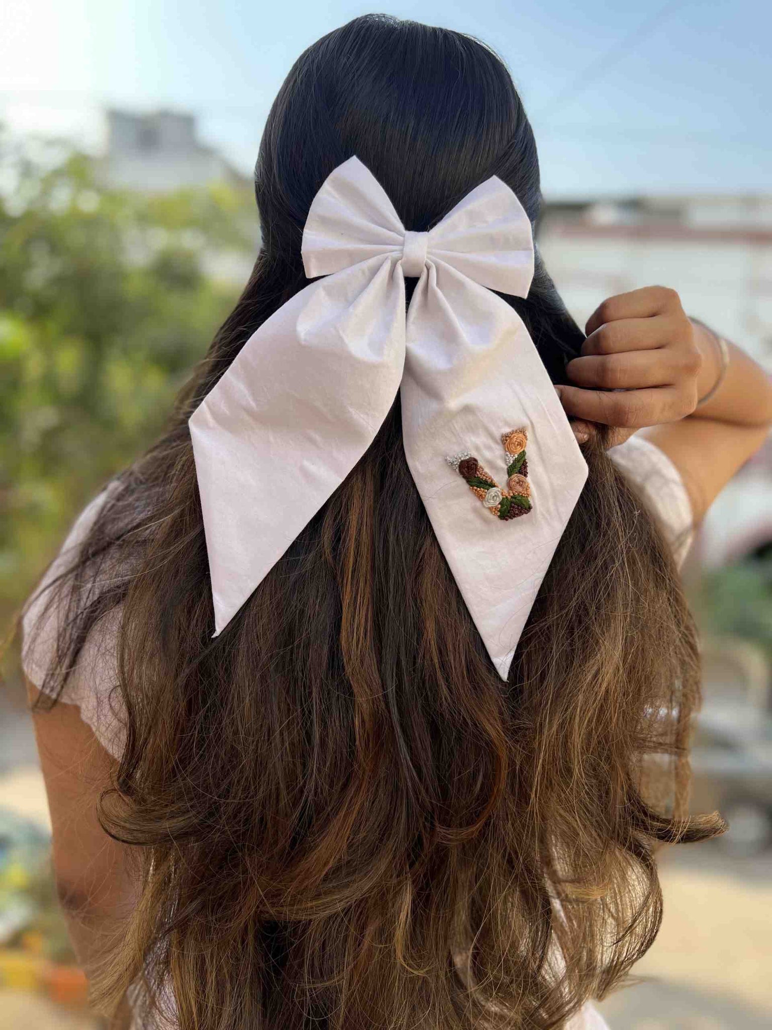 White embroidered bow initial