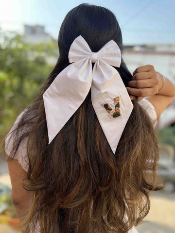 White embroidered bow initial