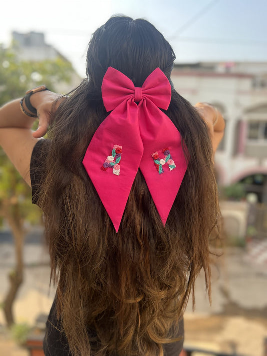 Pink embroidered bow with initials
