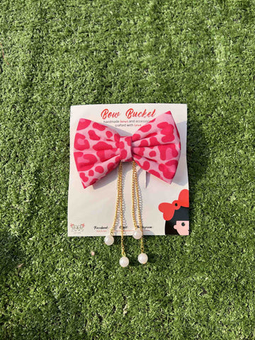 Pink cheetah hanging pearl bow clip